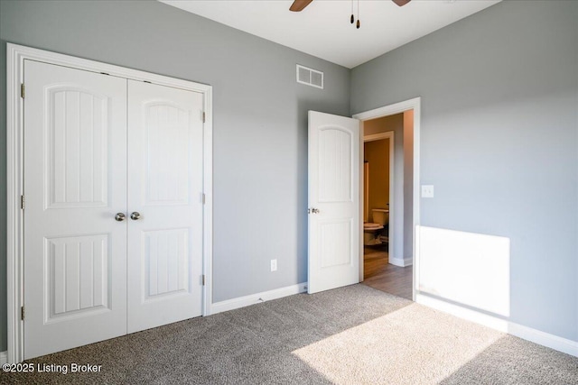 unfurnished bedroom with a closet, ceiling fan, and carpet