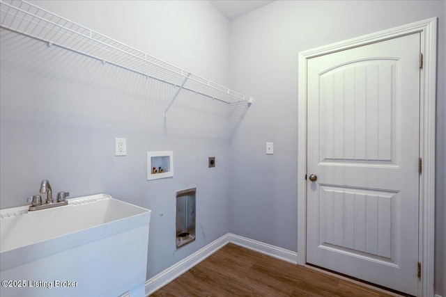 washroom with electric dryer hookup, sink, hookup for a washing machine, and dark hardwood / wood-style floors