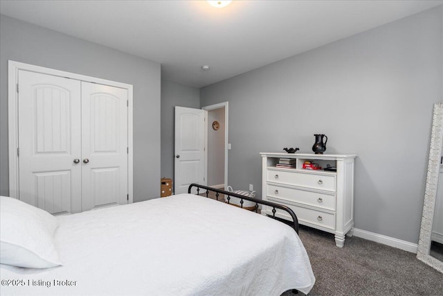 bedroom featuring dark colored carpet and a closet