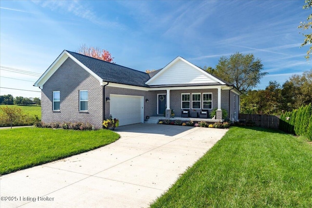 view of front of property with a porch, a garage, and a front yard