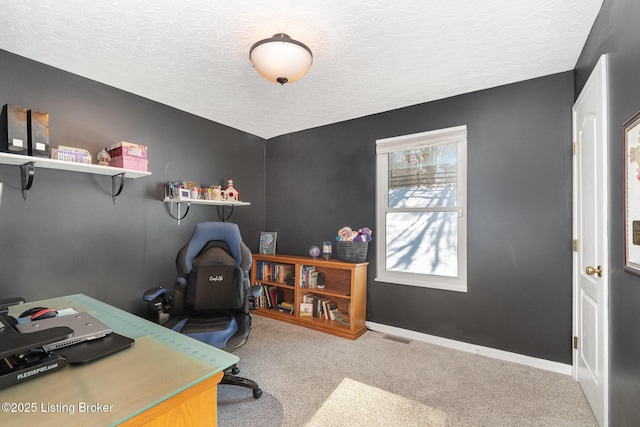 office space featuring light colored carpet and a textured ceiling