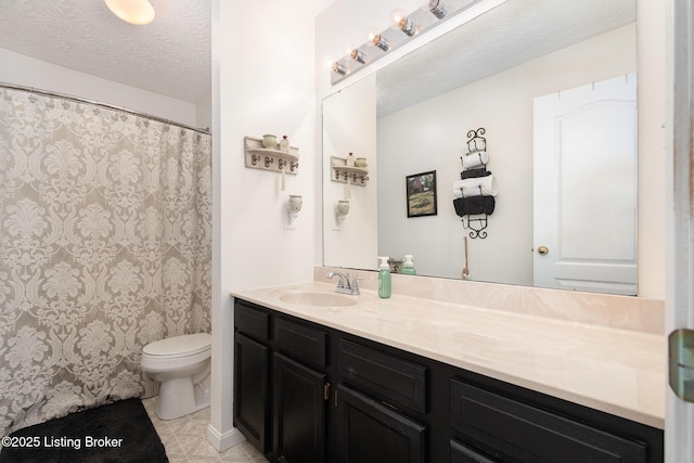 bathroom featuring tile patterned floors, vanity, toilet, and a textured ceiling