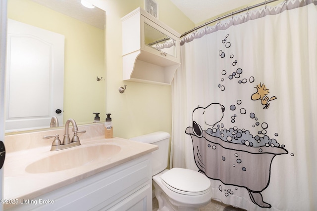 bathroom featuring vanity, toilet, and walk in shower