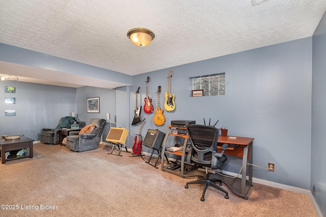 carpeted home office featuring a textured ceiling