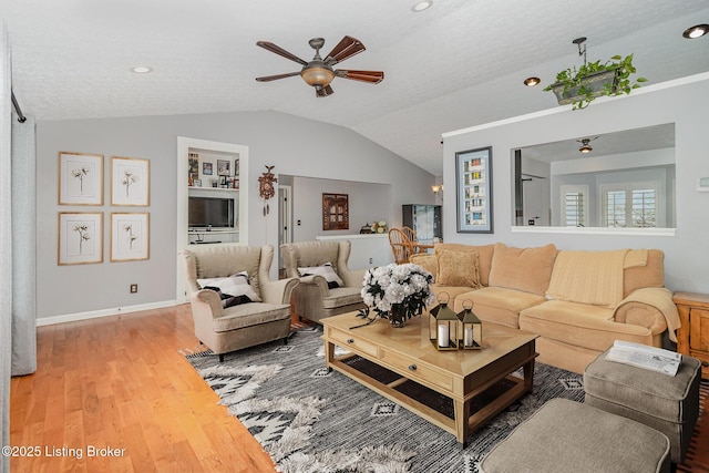 living room featuring lofted ceiling, hardwood / wood-style floors, a textured ceiling, and ceiling fan