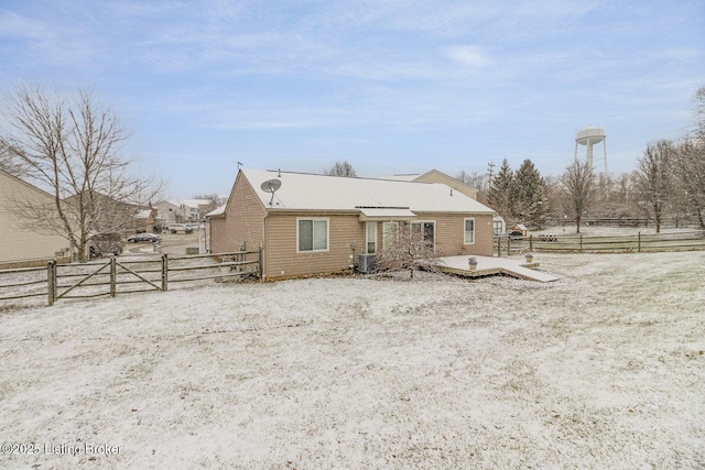 rear view of property with cooling unit and a deck