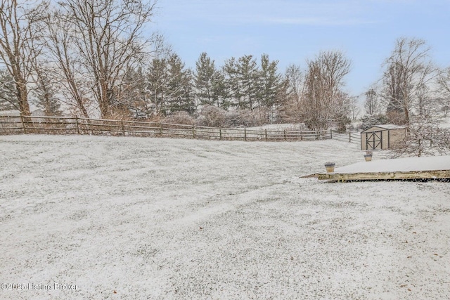 snowy yard with a shed