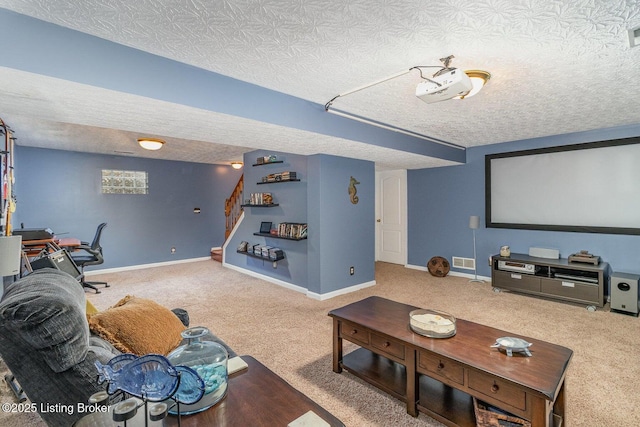 cinema room featuring carpet floors and a textured ceiling