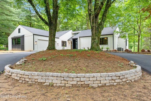 view of front of house featuring central AC unit and a garage