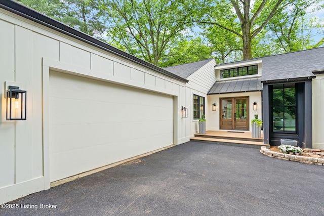 exterior space featuring a garage and french doors