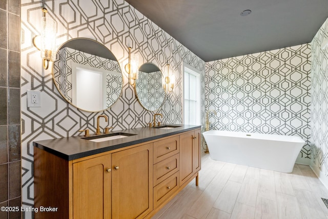 bathroom featuring vanity and a bath