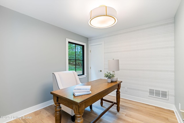 office space with light wood-type flooring