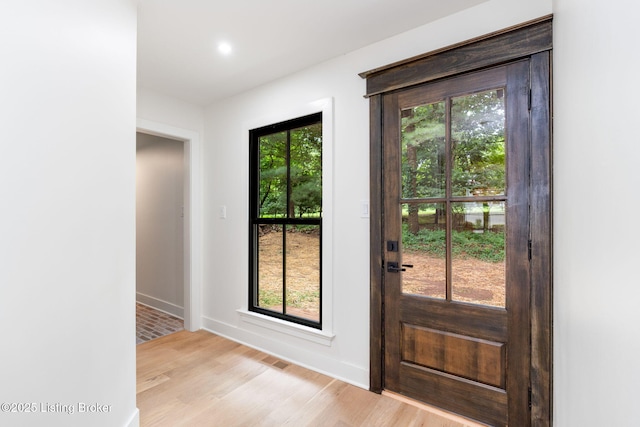 doorway with light wood-type flooring