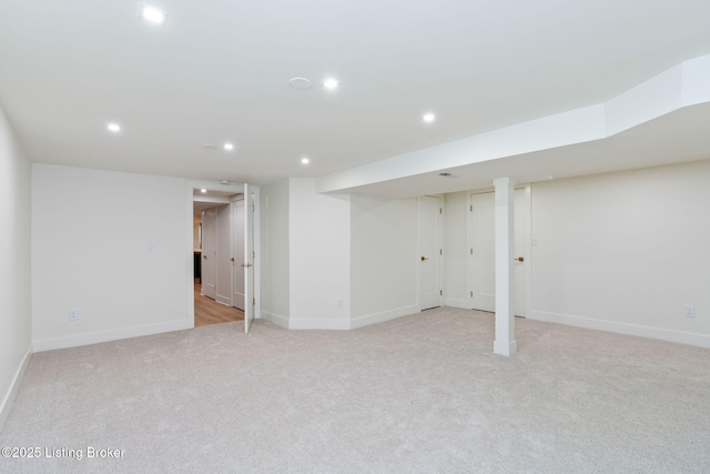 basement featuring light colored carpet