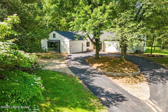 modern inspired farmhouse with a garage and central AC unit