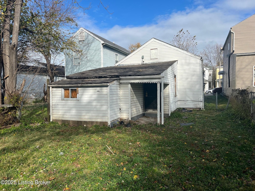 rear view of house with a yard