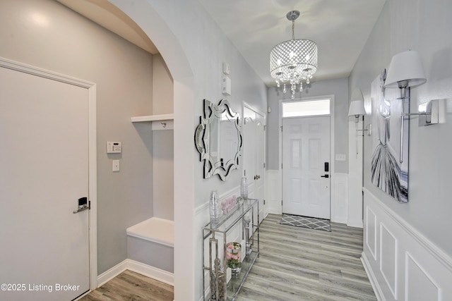 entryway with a notable chandelier and light hardwood / wood-style flooring