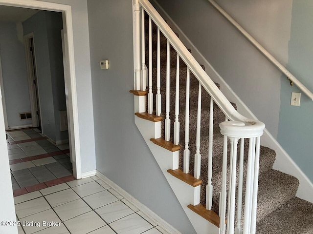 stairway featuring tile patterned floors