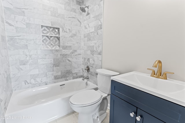 full bathroom with tiled shower / bath, vanity, and toilet