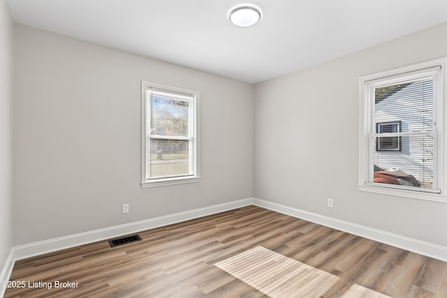 unfurnished room featuring a healthy amount of sunlight and light hardwood / wood-style flooring