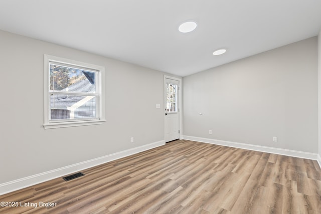empty room featuring plenty of natural light and light wood-type flooring