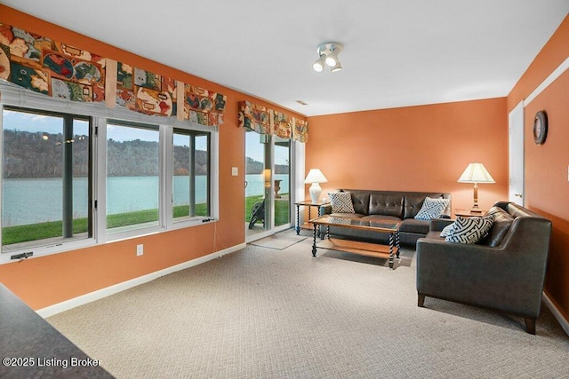 living room with carpet flooring and a water view