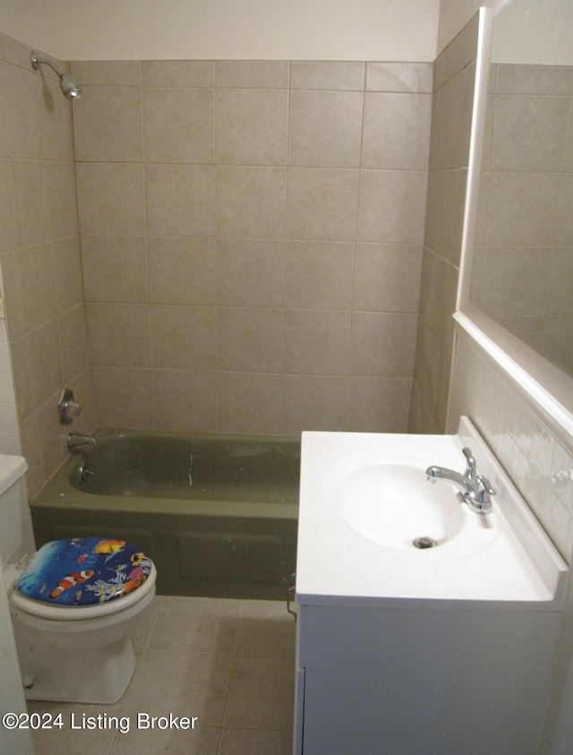 full bathroom with tiled shower / bath combo, vanity, tile patterned floors, and toilet