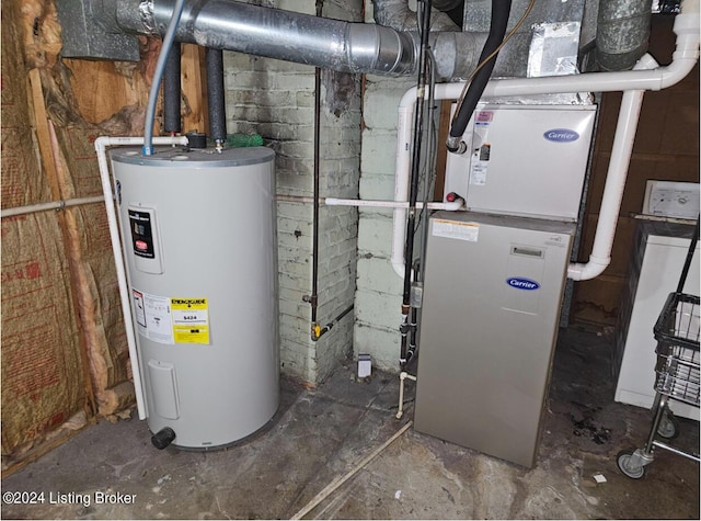 utility room featuring heating unit and electric water heater