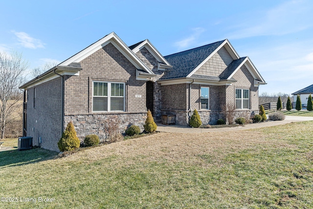 craftsman-style home with central AC and a front lawn