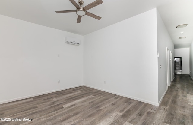 empty room with dark wood-type flooring, ceiling fan, and a wall mounted air conditioner