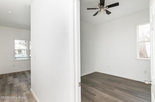 empty room featuring ceiling fan and dark hardwood / wood-style flooring