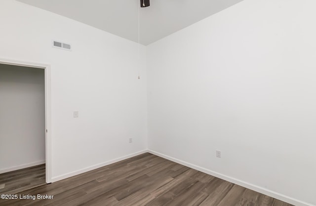 empty room with dark wood-type flooring