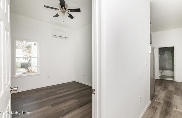 unfurnished room featuring dark hardwood / wood-style flooring, ceiling fan, and a wall unit AC