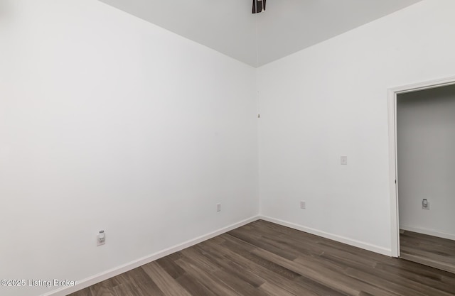 unfurnished room with ceiling fan and dark hardwood / wood-style flooring