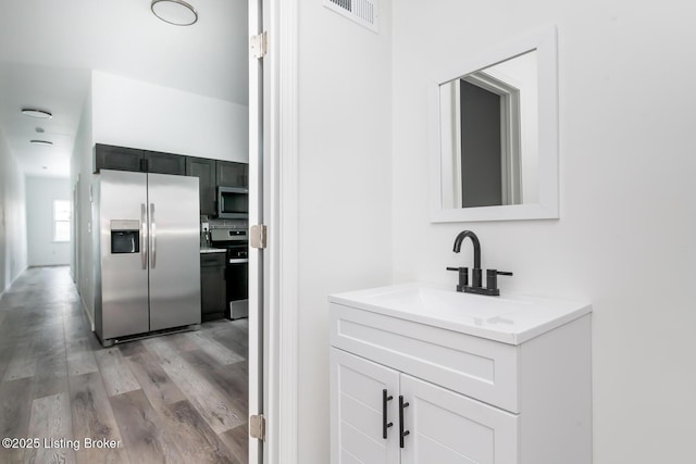 bathroom with vanity and wood-type flooring