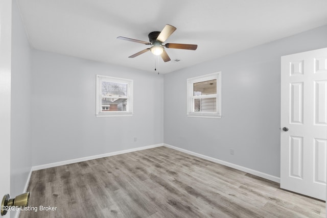 empty room featuring ceiling fan and light wood-type flooring