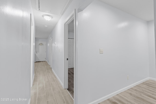 corridor with light wood-type flooring