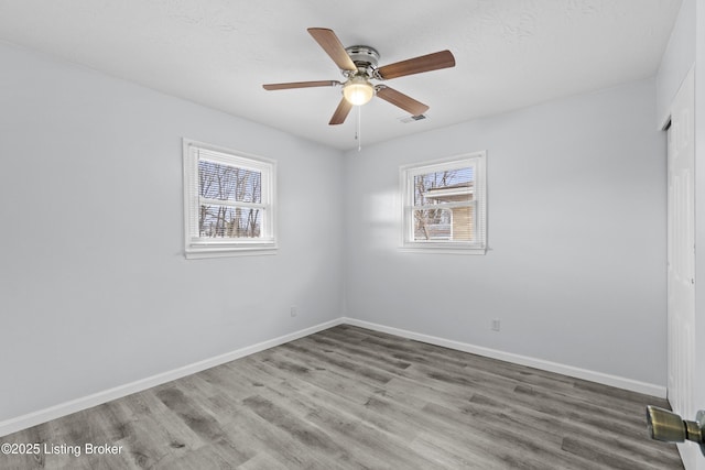 unfurnished room with ceiling fan and hardwood / wood-style floors