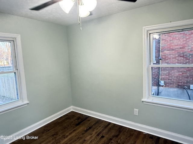 empty room featuring ceiling fan, dark hardwood / wood-style flooring, and a textured ceiling