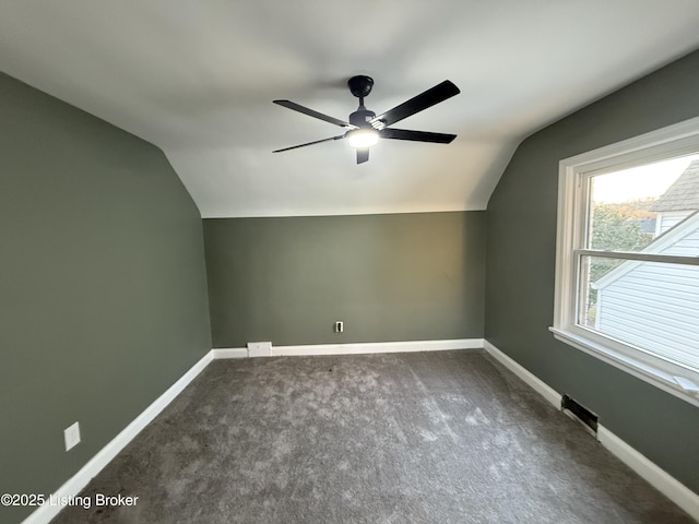 bonus room with ceiling fan, lofted ceiling, and dark carpet