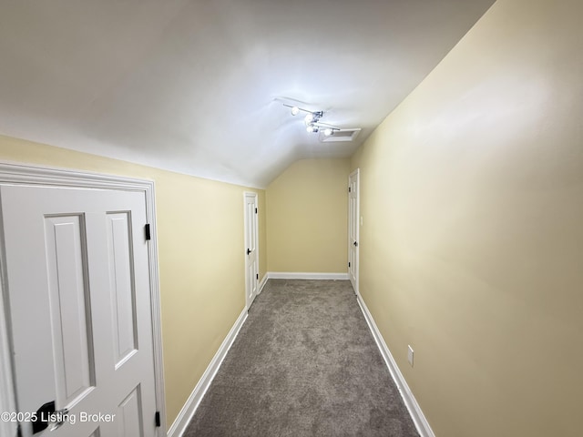 hall featuring vaulted ceiling and carpet