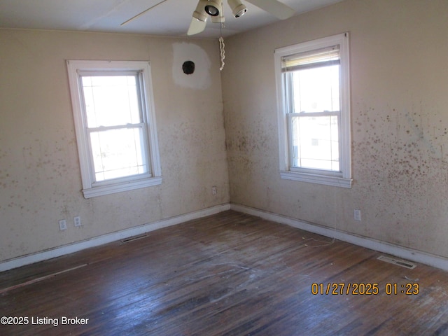 spare room featuring dark hardwood / wood-style flooring and ceiling fan