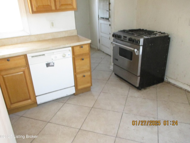 kitchen featuring light tile patterned floors, gas stove, and dishwasher