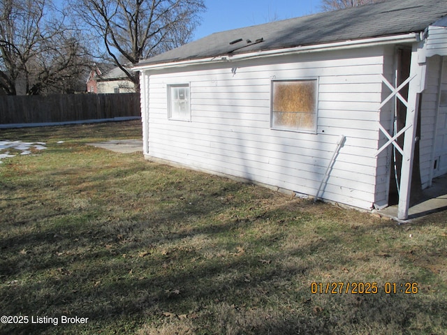 view of side of home with a lawn