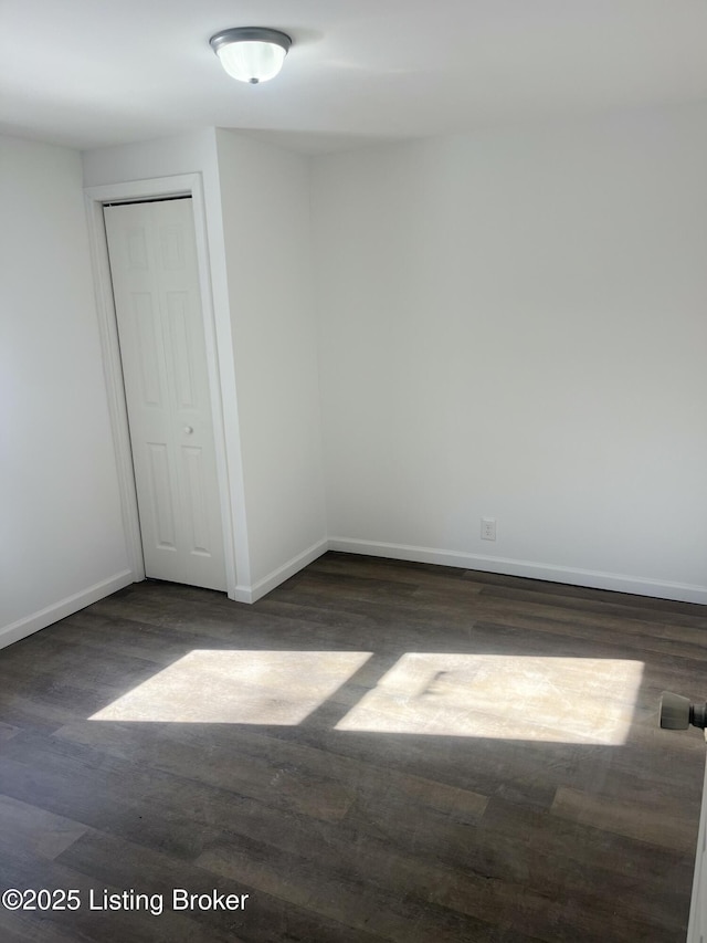 unfurnished room featuring dark hardwood / wood-style floors