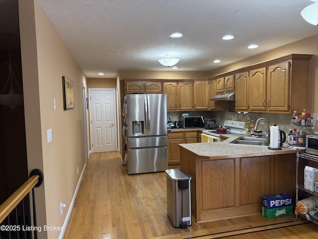 kitchen featuring white electric range oven, stainless steel fridge with ice dispenser, light hardwood / wood-style flooring, kitchen peninsula, and backsplash