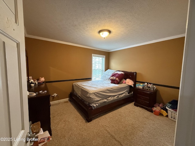 bedroom with ornamental molding, a textured ceiling, and carpet