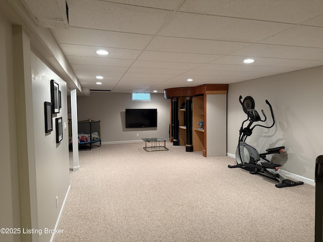 exercise area with a paneled ceiling and carpet flooring