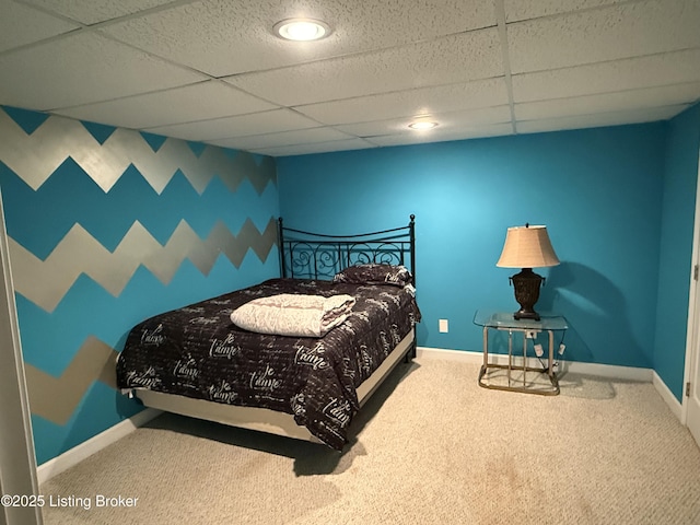 bedroom with a drop ceiling and carpet flooring