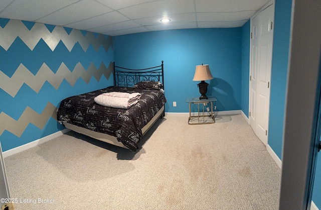 bedroom featuring carpet floors and a paneled ceiling